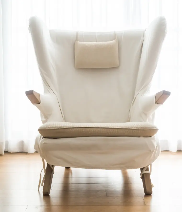From Old Fabric to Fresh Look – A white modern armchair with a padded seat, representing the transformation of furniture through high-quality chair upholstery in Bahrain.